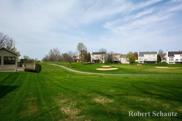 view of property's community with a residential view and a yard