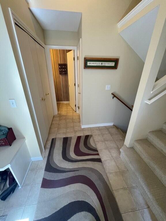 interior space featuring stairway and light tile patterned flooring
