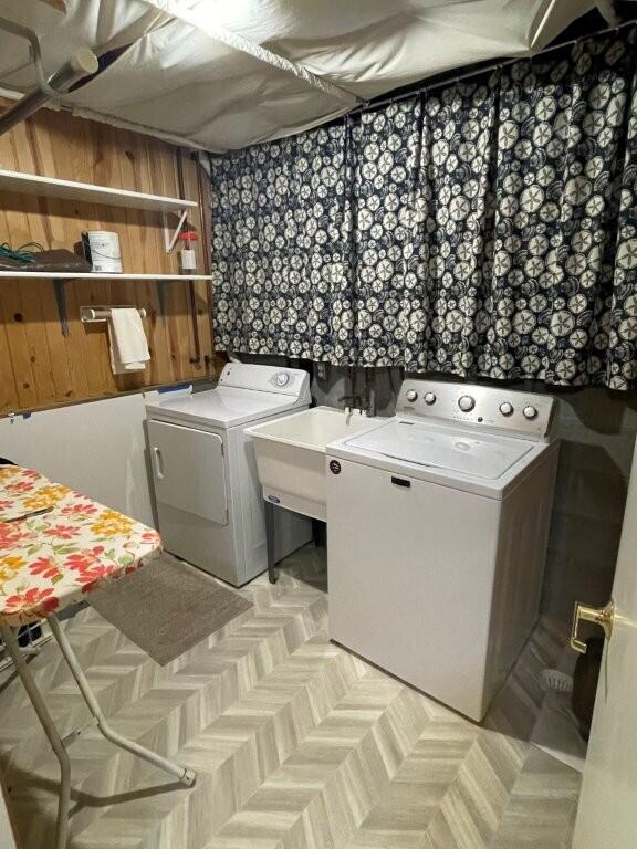 laundry area featuring a sink, washing machine and clothes dryer, and laundry area