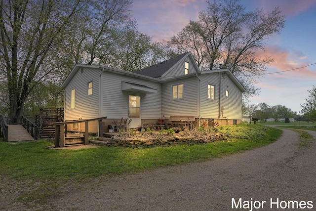1864 92nd St SW, Byron Center, MI 49315 - view of side of home featuring a wooden deck, dirt driveway, and a lawn