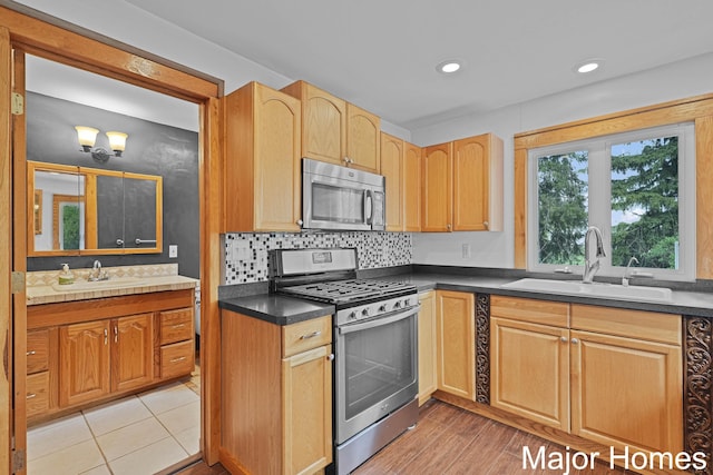 1864 92nd St SW, Byron Center, MI 49315 - kitchen featuring stainless steel appliances, a sink, dark countertops, decorative backsplash, and recessed lighting