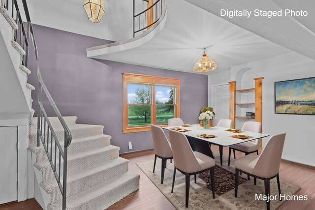 1864 92nd St SW, Byron Center, MI 49315 - dining area featuring stairs, a chandelier, wood finished floors, and baseboards