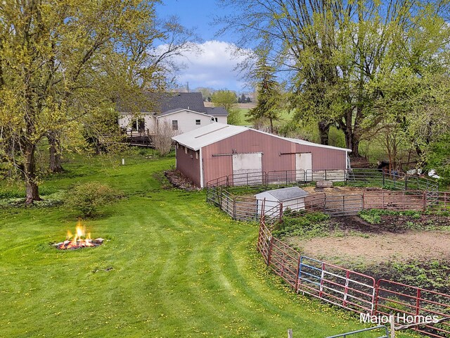 1864 92nd St SW, Byron Center, MI 49315 - view of yard featuring a pole building, an outdoor fire pit, an outdoor structure, and an exterior structure