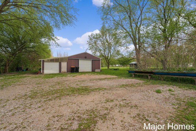 1864 92nd St SW, Byron Center, MI 49315 - view of yard with a detached garage, an outbuilding, and a pole building