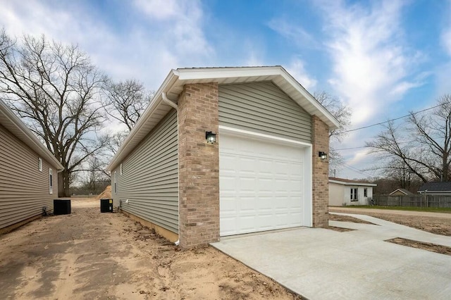 308 Hillview St, Buchanan, MI 49107 - view of side of home featuring an attached garage, cooling unit, and driveway