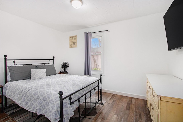 bedroom with hardwood / wood-style floors and baseboards