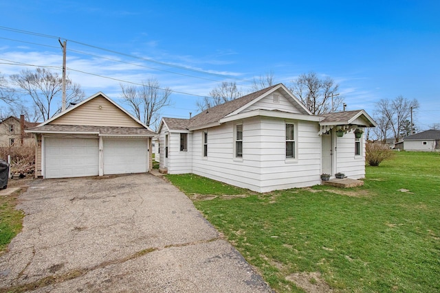 view of front of house featuring a garage, a front yard, and a shingled roof
