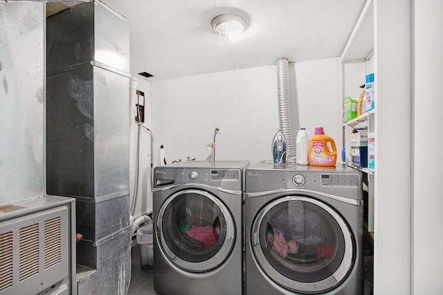 laundry room featuring separate washer and dryer and laundry area