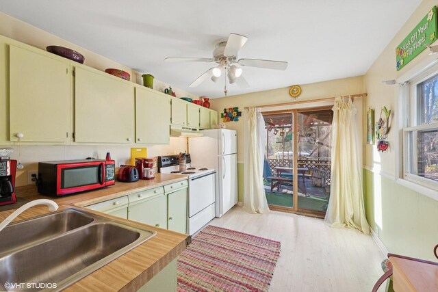 46353 Grand Beach Rd, Grand Beach, MI 49117 - kitchen with light wood-type flooring, white appliances, light countertops, under cabinet range hood, and a sink