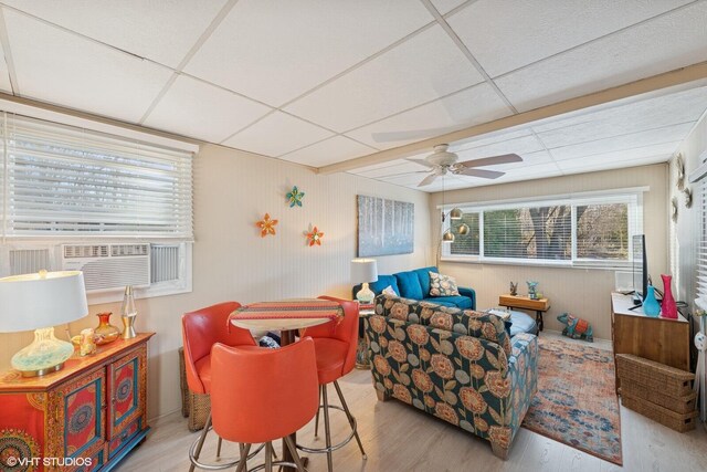 46353 Grand Beach Rd, Grand Beach, MI 49117 - living area featuring a paneled ceiling, cooling unit, a ceiling fan, wood walls, and wood finished floors