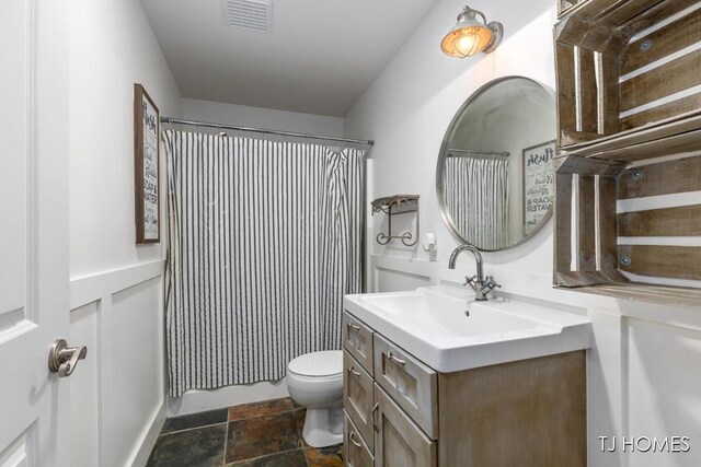 3969 Murray View Ave NE, Lowell, MI 49331 - full bathroom featuring vanity, a shower with curtain, toilet, stone finish floor, and visible vents