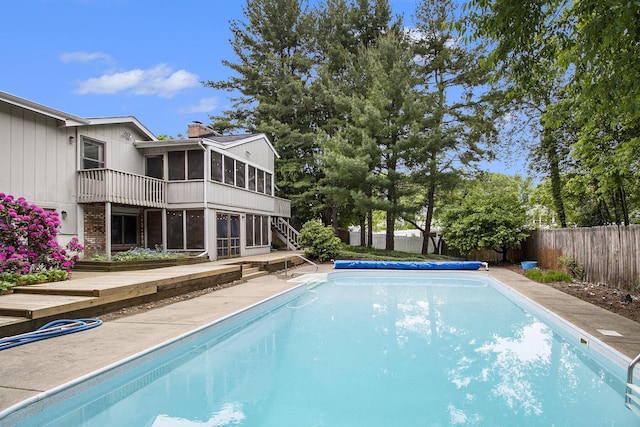 8170 Talaria Ter, Kalamazoo, MI 49009 - view of pool featuring a fenced backyard, stairs, and a sunroom