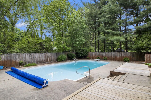 8170 Talaria Ter, Kalamazoo, MI 49009 - view of pool featuring a fenced backyard, a deck, a patio area, and a diving board