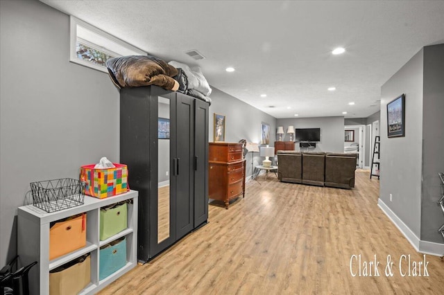 interior space with recessed lighting, light wood-type flooring, visible vents, and baseboards