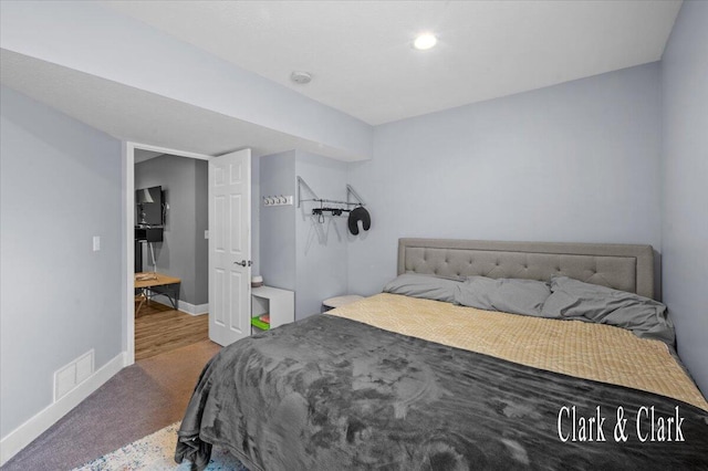 carpeted bedroom with visible vents and baseboards