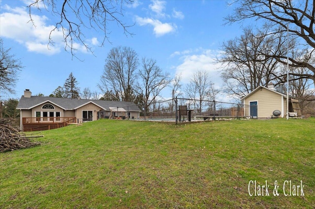 view of yard with fence and a deck
