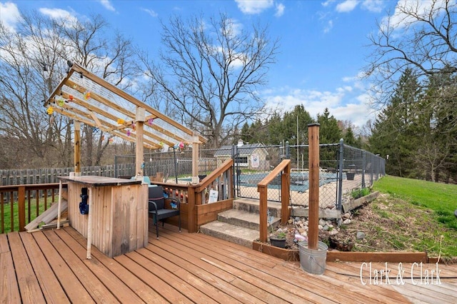 wooden terrace with a fenced backyard
