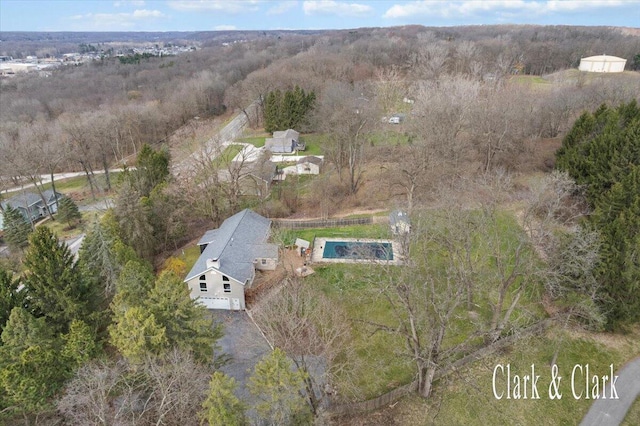 birds eye view of property with a wooded view