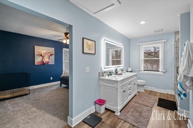 ensuite bathroom with vanity, toilet, baseboards, a shower with door, and ensuite bath