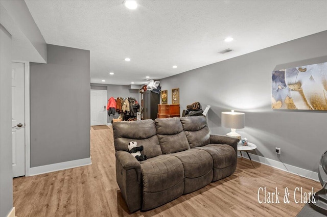 living room featuring recessed lighting, wood finished floors, and baseboards