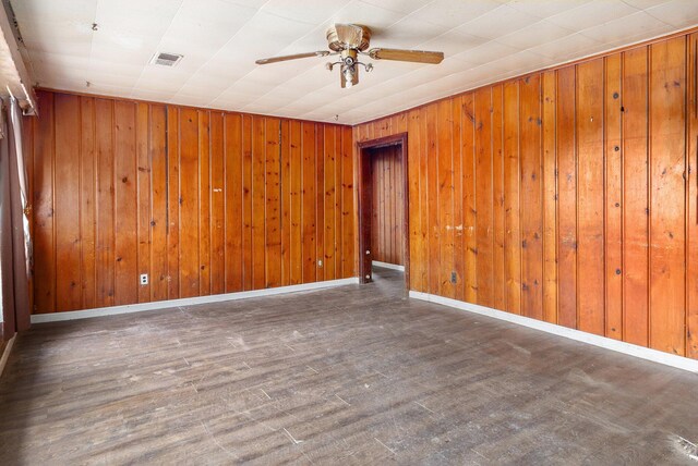 3309 Greenfield Ave, Kalamazoo, MI 49048 - empty room featuring wooden walls, visible vents, ceiling fan, and baseboards
