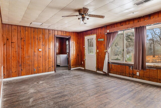3309 Greenfield Ave, Kalamazoo, MI 49048 - spare room featuring visible vents, baseboards, ceiling fan, wooden walls, and wood finished floors