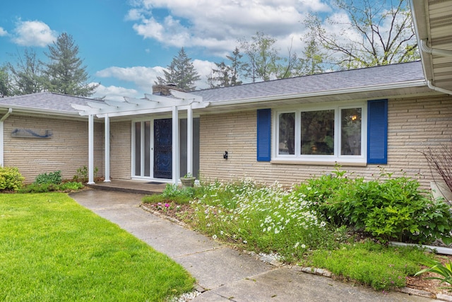 3010 Hill An Brook Dr, Portage, MI 49024 - property entrance featuring a pergola, brick siding, a yard, a chimney, and roof with shingles