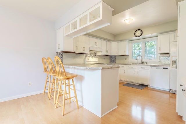 3010 Hill An Brook Dr, Portage, MI 49024 - kitchen featuring dishwasher, range, a peninsula, light wood-style floors, and a sink