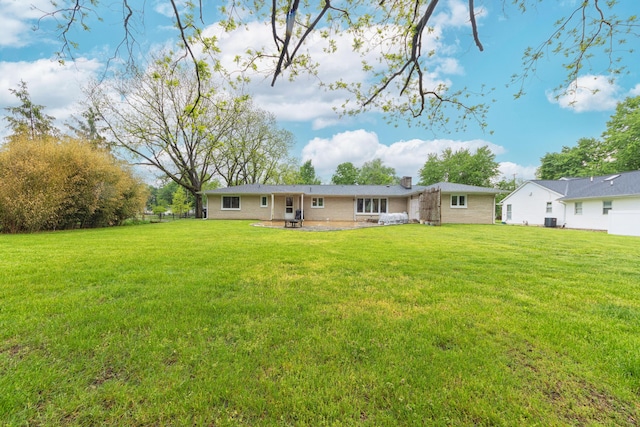 3010 Hill An Brook Dr, Portage, MI 49024 - rear view of property with a chimney, a yard, a patio area, and cooling unit