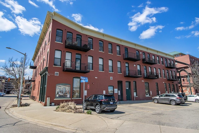 view of building exterior with uncovered parking