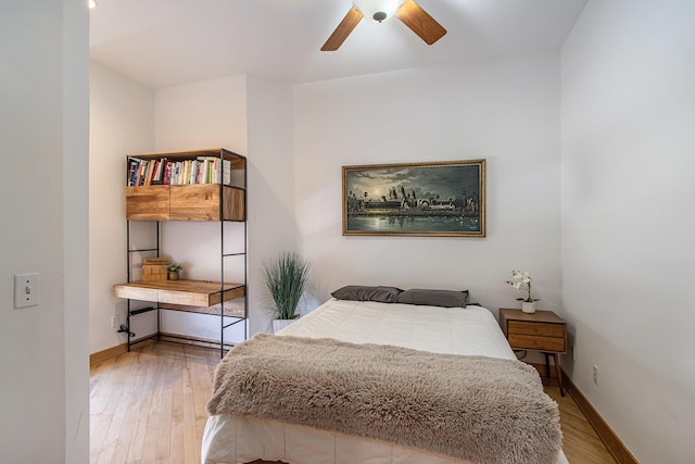 bedroom with baseboards, a ceiling fan, and wood finished floors