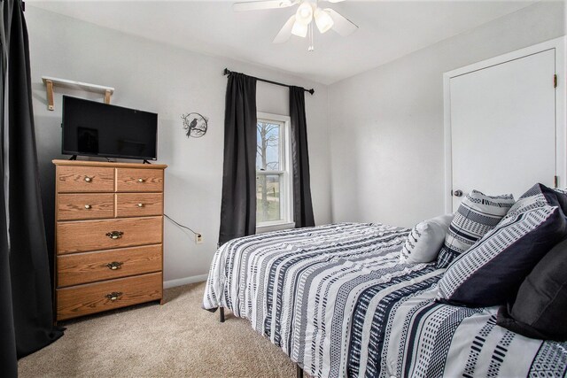 13627 Cadmus Rd, Hudson, MI 49247 - bedroom with light carpet, a ceiling fan, and baseboards