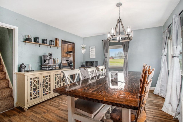 13627 Cadmus Rd, Hudson, MI 49247 - dining space featuring stairs, a notable chandelier, and wood finished floors