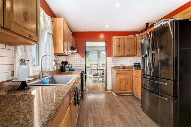 13627 Cadmus Rd, Hudson, MI 49247 - kitchen featuring under cabinet range hood, backsplash, a sink, stainless steel fridge, and dark wood-style flooring