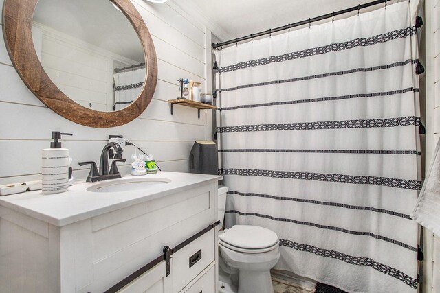 13627 Cadmus Rd, Hudson, MI 49247 - full bathroom featuring vanity, wooden walls, a shower with curtain, toilet, and ornamental molding