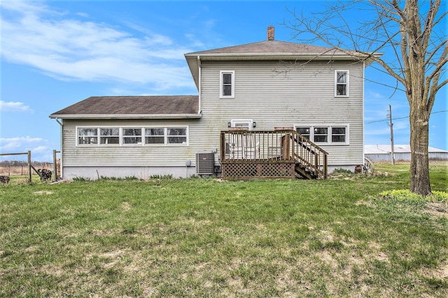 13627 Cadmus Rd, Hudson, MI 49247 - rear view of house featuring central AC unit, a lawn, a chimney, a shingled roof, and a wooden deck