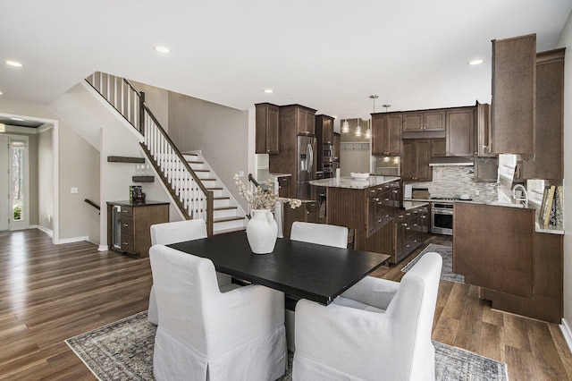 dining room with recessed lighting, stairway, dark wood-style flooring, and baseboards