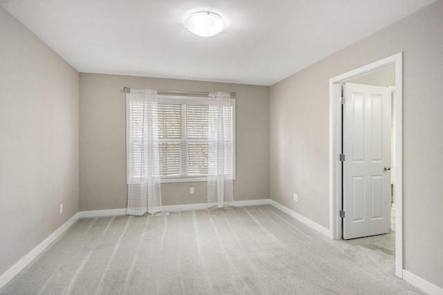 empty room with carpet floors and baseboards