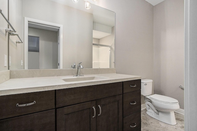 full bathroom with vanity, an enclosed shower, baseboards, and toilet