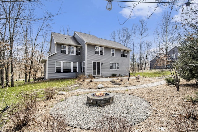 back of house featuring an outdoor fire pit and entry steps
