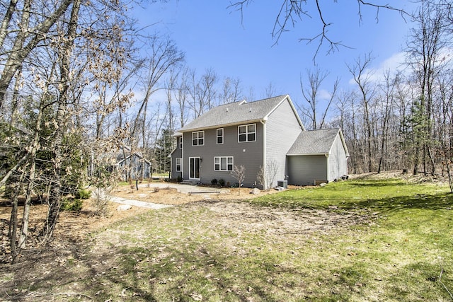 rear view of property featuring a lawn