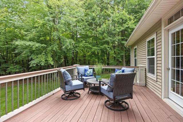8702 E 98th St, Howard City, MI 49329 - wooden terrace featuring an outdoor living space, a view of trees, and a lawn