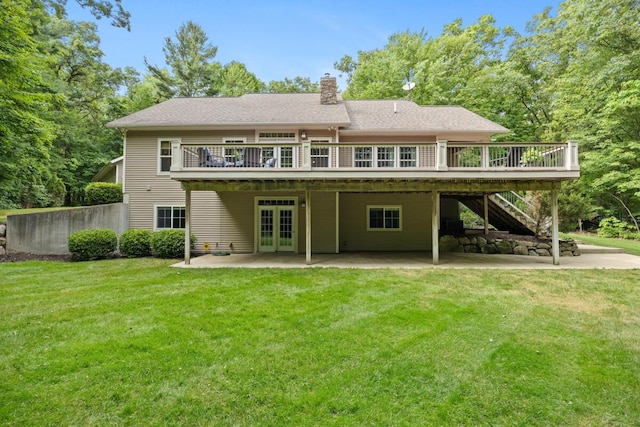 8702 E 98th St, Howard City, MI 49329 - rear view of house featuring french doors, a wooden deck, a patio, and a lawn