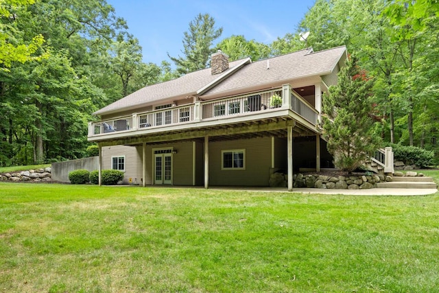 8702 E 98th St, Howard City, MI 49329 - rear view of property featuring french doors, a lawn, a chimney, and a wooden deck