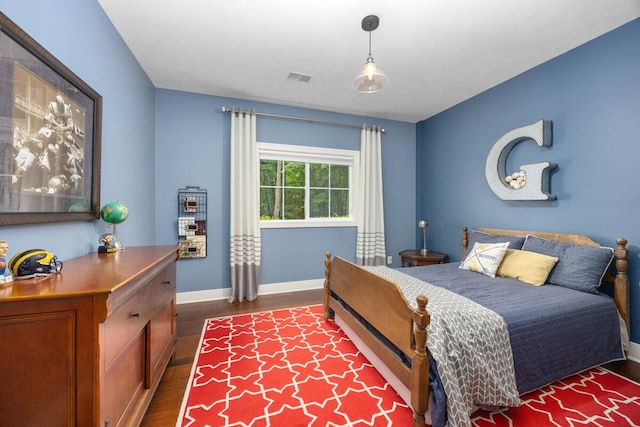 8702 E 98th St, Howard City, MI 49329 - bedroom featuring dark wood-style floors and baseboards