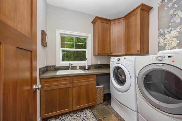 8702 E 98th St, Howard City, MI 49329 - washroom featuring separate washer and dryer, cabinet space, and dark stone finish floors