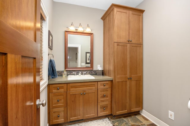 8702 E 98th St, Howard City, MI 49329 - bathroom featuring vanity and stone finish flooring