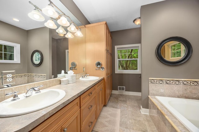 8702 E 98th St, Howard City, MI 49329 - bathroom featuring double vanity, a garden tub, and a chandelier