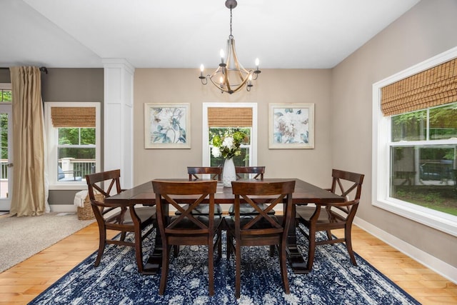 8702 E 98th St, Howard City, MI 49329 - dining area featuring healthy amount of natural light, a chandelier, and light wood-style flooring