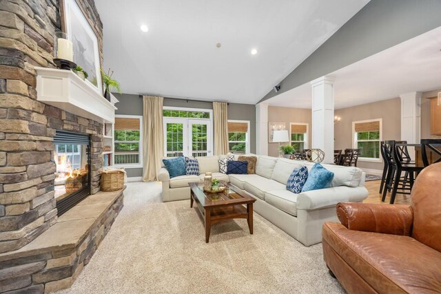 8702 E 98th St, Howard City, MI 49329 - living area featuring a stone fireplace, ornate columns, healthy amount of natural light, recessed lighting, and high vaulted ceiling